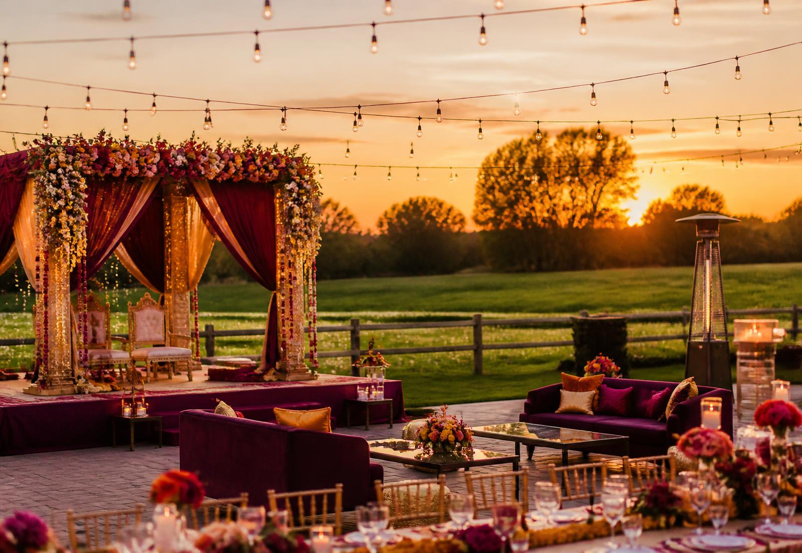 Decorated Punjabi farm wedding setup at sunset with string lights
